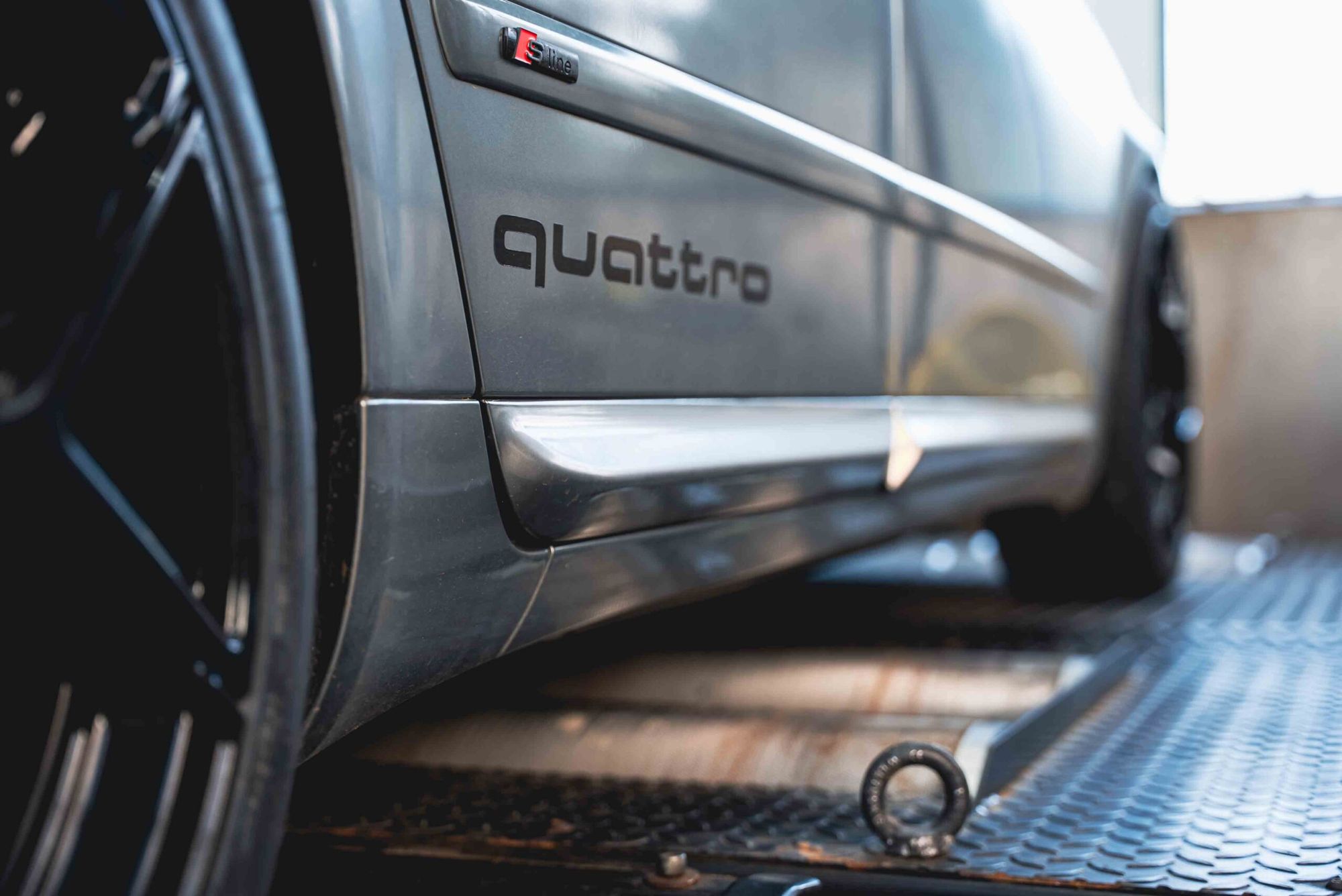 Seitenschweller eines Audi mit quattro-Schriftzug